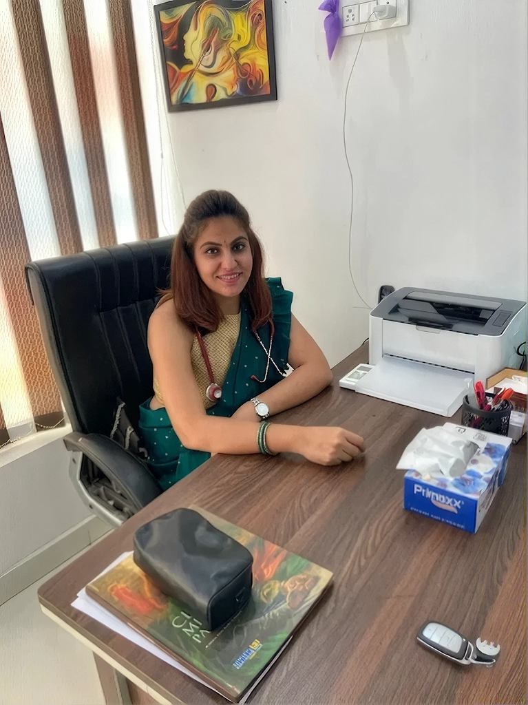Dr. Anjali Sharma, a doctor at HappyMindz Clinic, smiles at her desk.